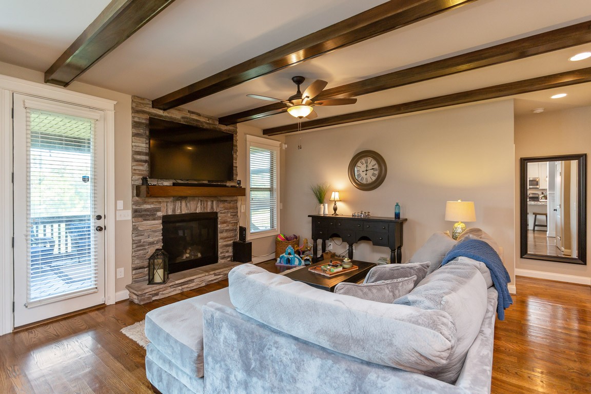 3501 Earhart Road Mount Juliet, TN 37122 - Photo 20 of 42 a living room with furniture a fireplace and a flat screen tv