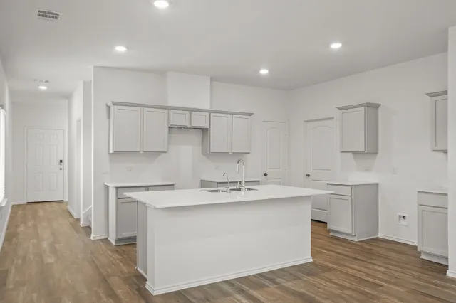 a kitchen with a sink stainless steel appliances and cabinets