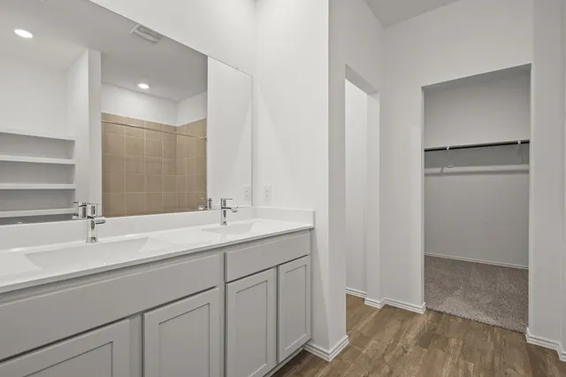 a bathroom with a double vanity sink and mirror