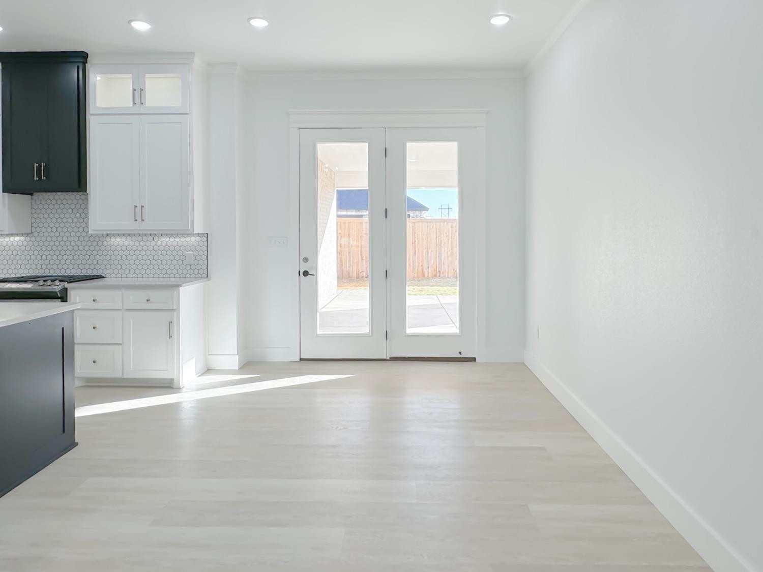 1301 Abbey Road Wolfforth, TX 79382 - Photo 11 of 24 a view of an empty room with window and wooden floor