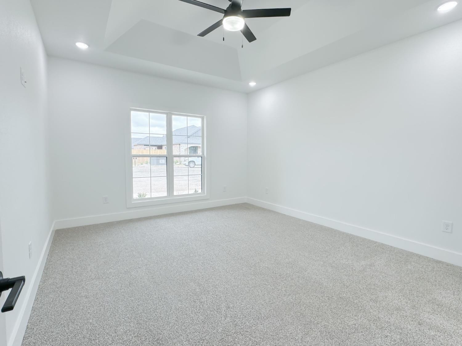 1301 Abbey Road Wolfforth, TX 79382 - Photo 13 of 24 an empty room with a ceiling fan and window