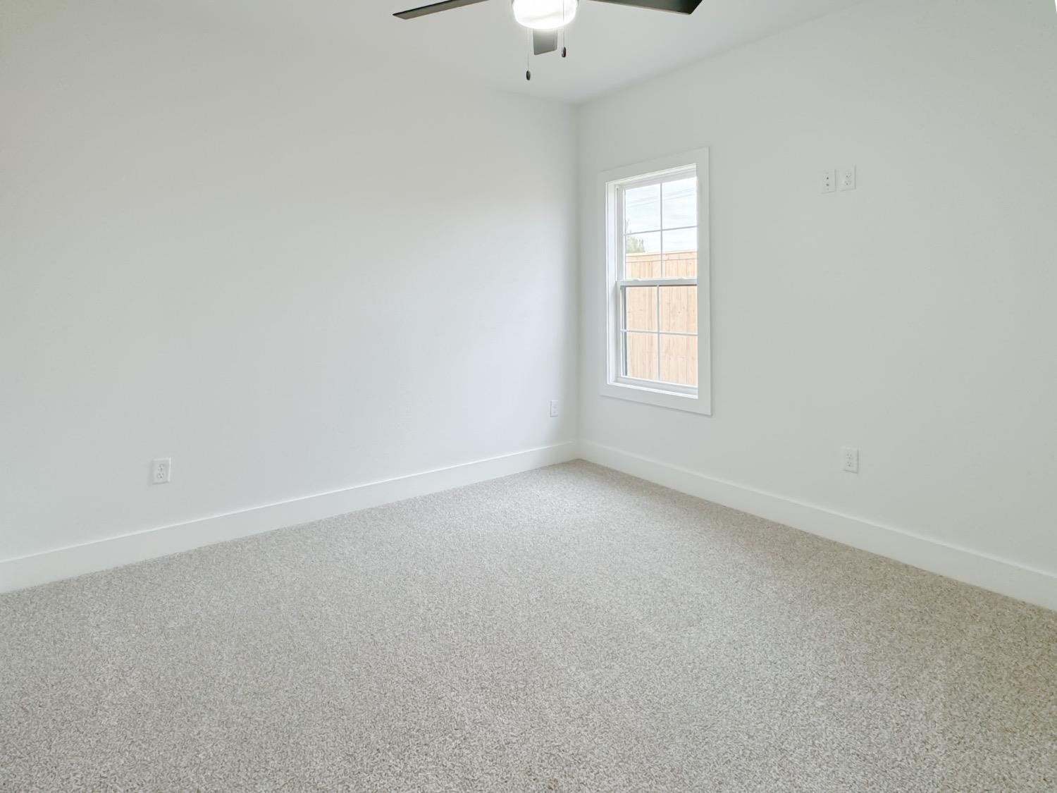 1301 Abbey Road Wolfforth, TX 79382 - Photo 18 of 24 an empty room with windows and entrance
