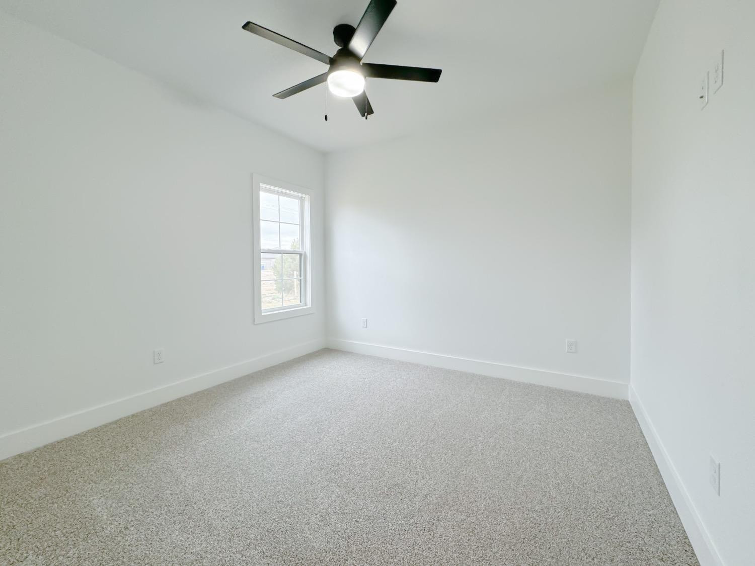 1301 Abbey Road Wolfforth, TX 79382 - Photo 19 of 24 an empty room with a window and a fan