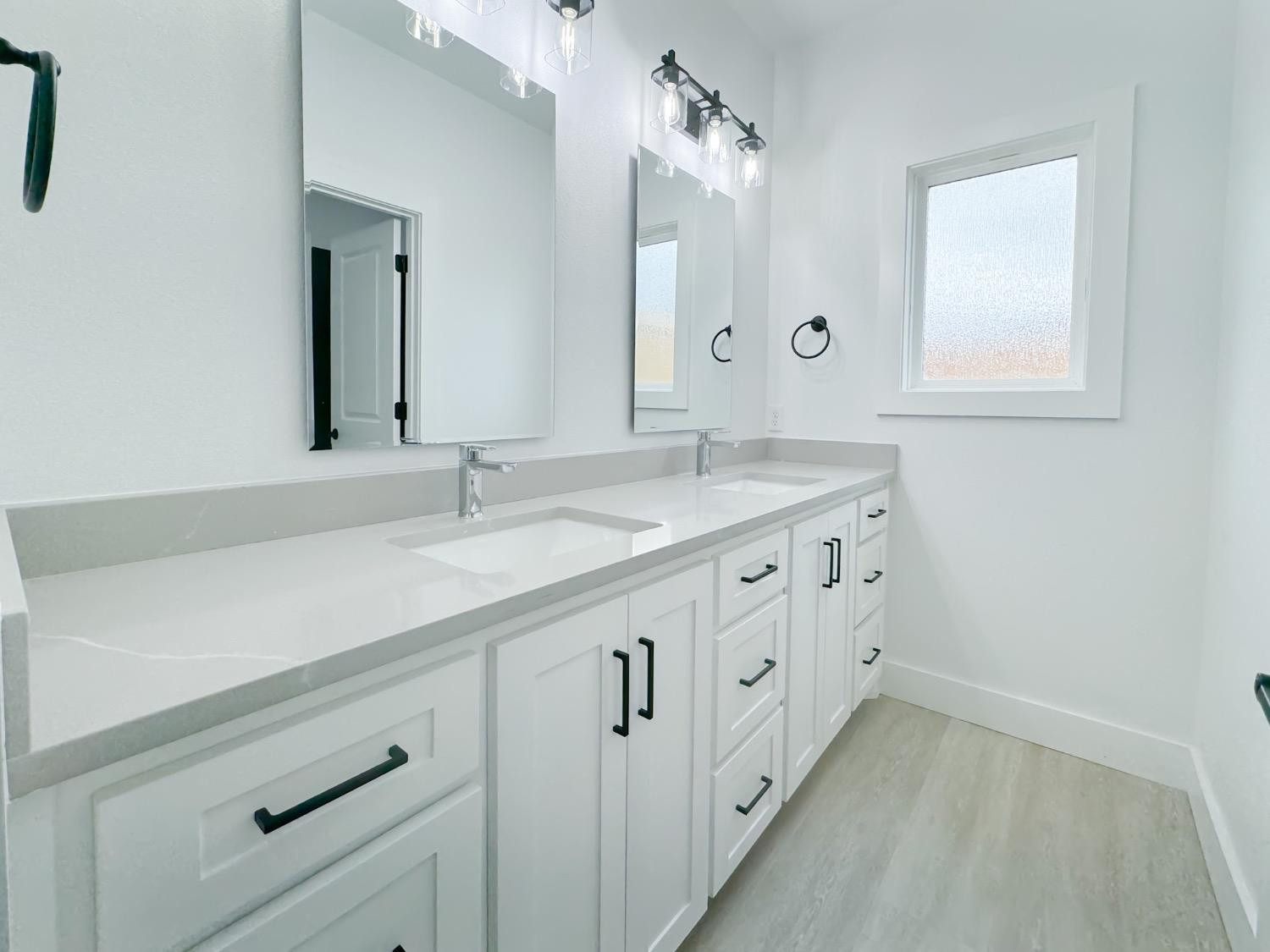 1301 Abbey Road Wolfforth, TX 79382 - Photo 21 of 24 a bathroom with a double vanity sink and mirror