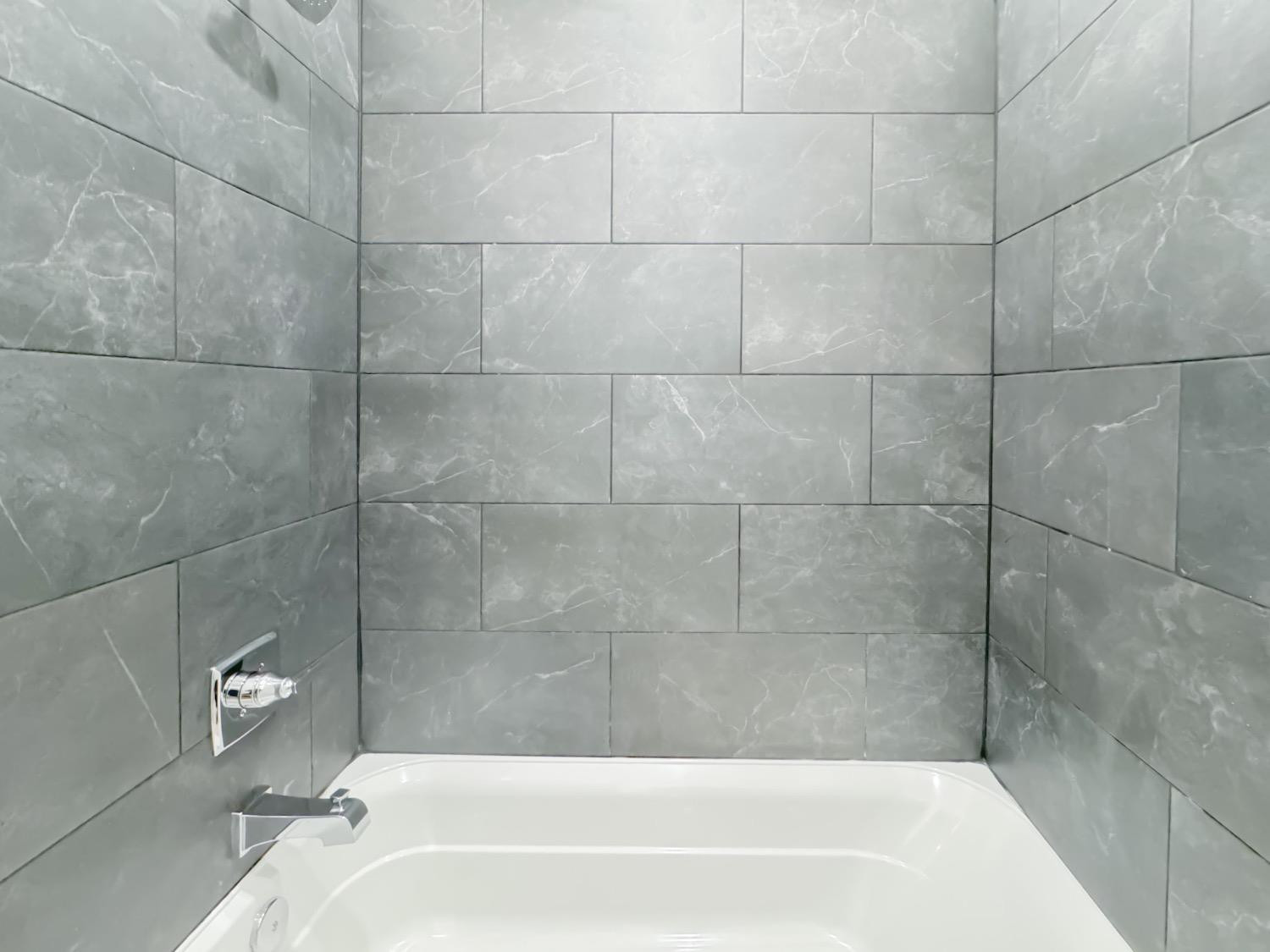 1301 Abbey Road Wolfforth, TX 79382 - Photo 23 of 24 a bath tub sitting next to a white sink and a shower