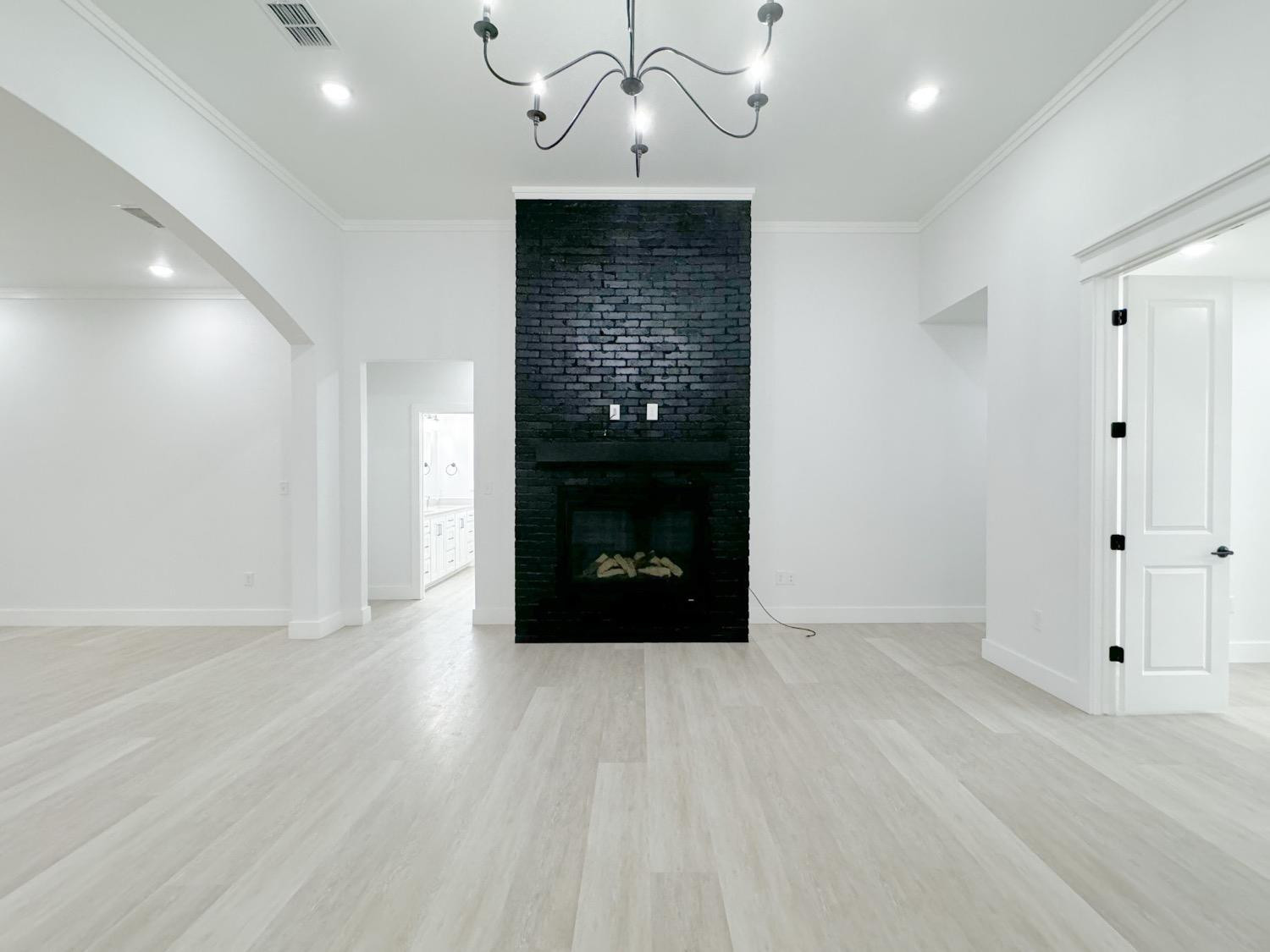 1301 Abbey Road Wolfforth, TX 79382 - Photo 4 of 24 a view of a hallway with wooden floor and staircase