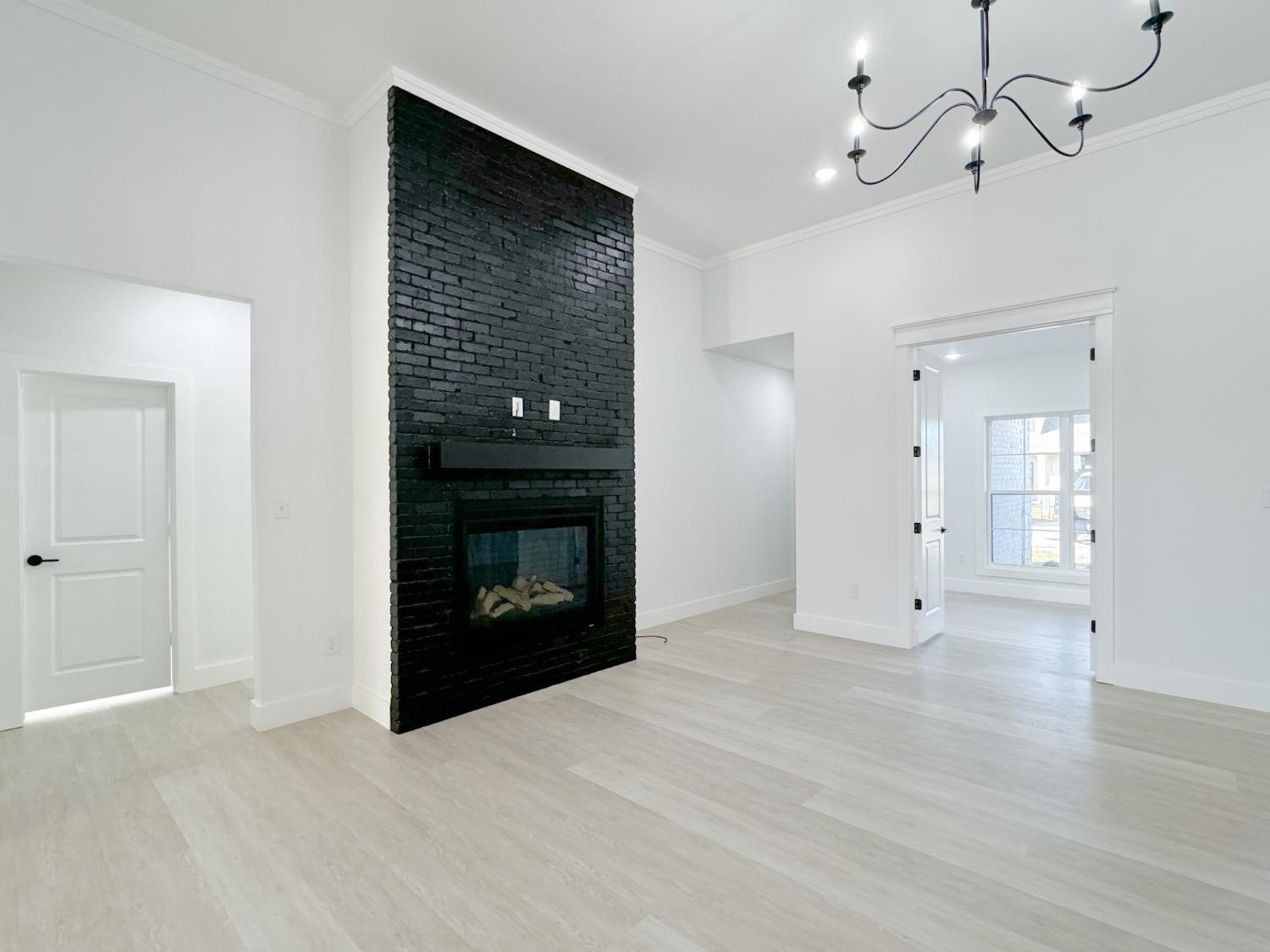 1301 Abbey Road Wolfforth, TX 79382 - Photo 5 of 24 a view of an empty room with a fireplace and a window
