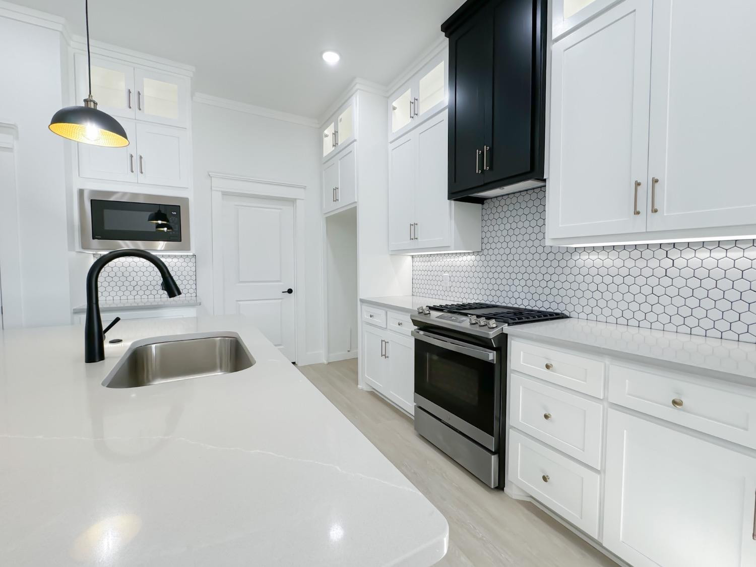 1301 Abbey Road Wolfforth, TX 79382 - Photo 7 of 24 a kitchen with stainless steel appliances granite countertop a sink a stove and a refrigerator
