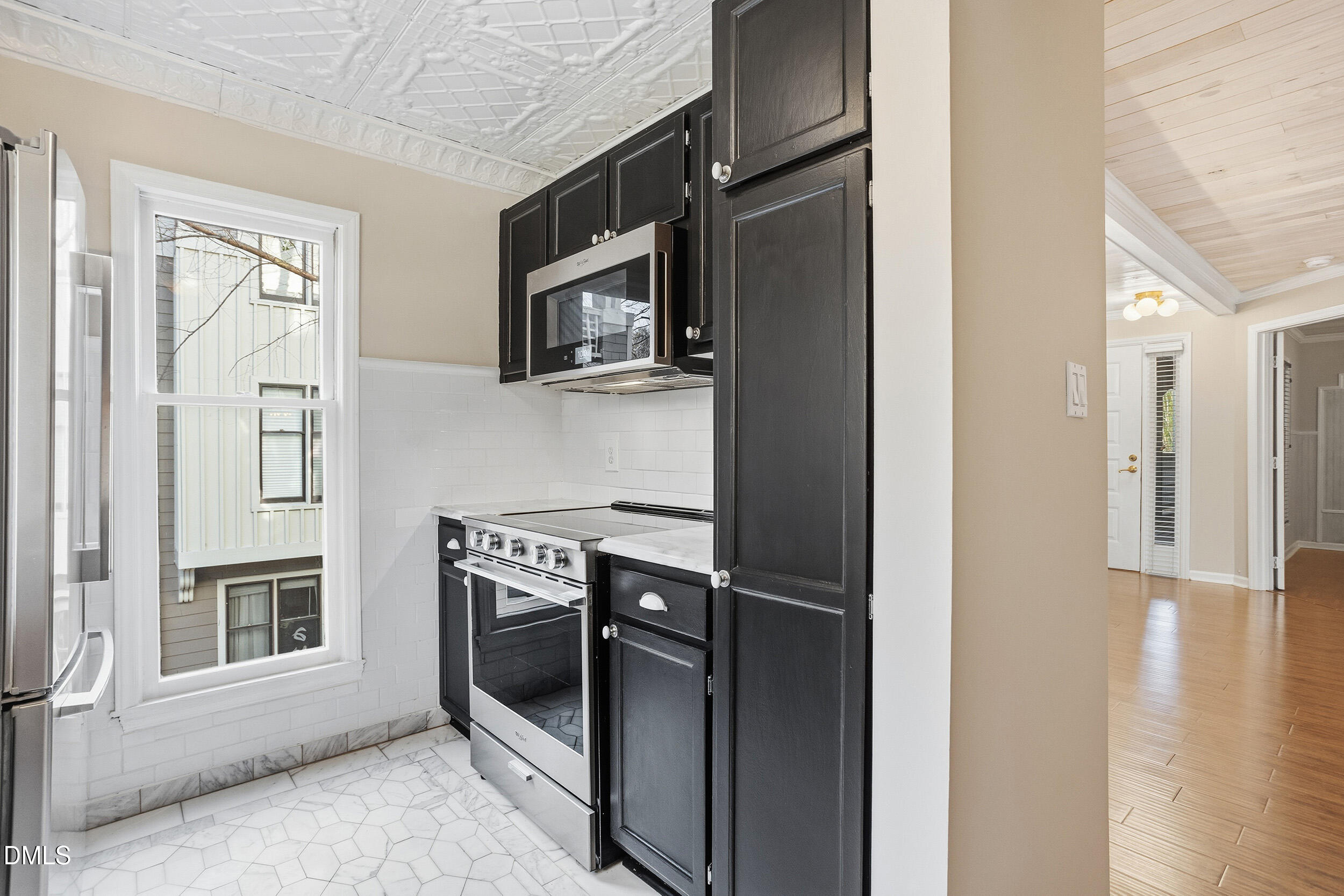 730 Washington Street, Unit 205 Raleigh, NC 27605 - Photo 10 of 23 a kitchen with stainless steel appliances a refrigerator and a microwave