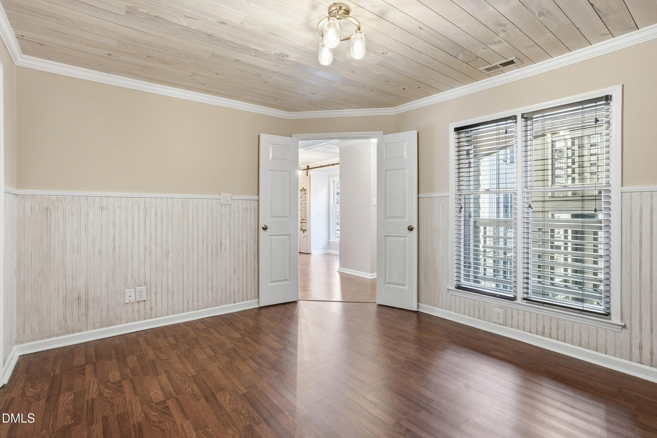 730 Washington Street, Unit 205 Raleigh, NC 27605 - Photo 17 of 23 a view of an empty room with wooden floor and a window