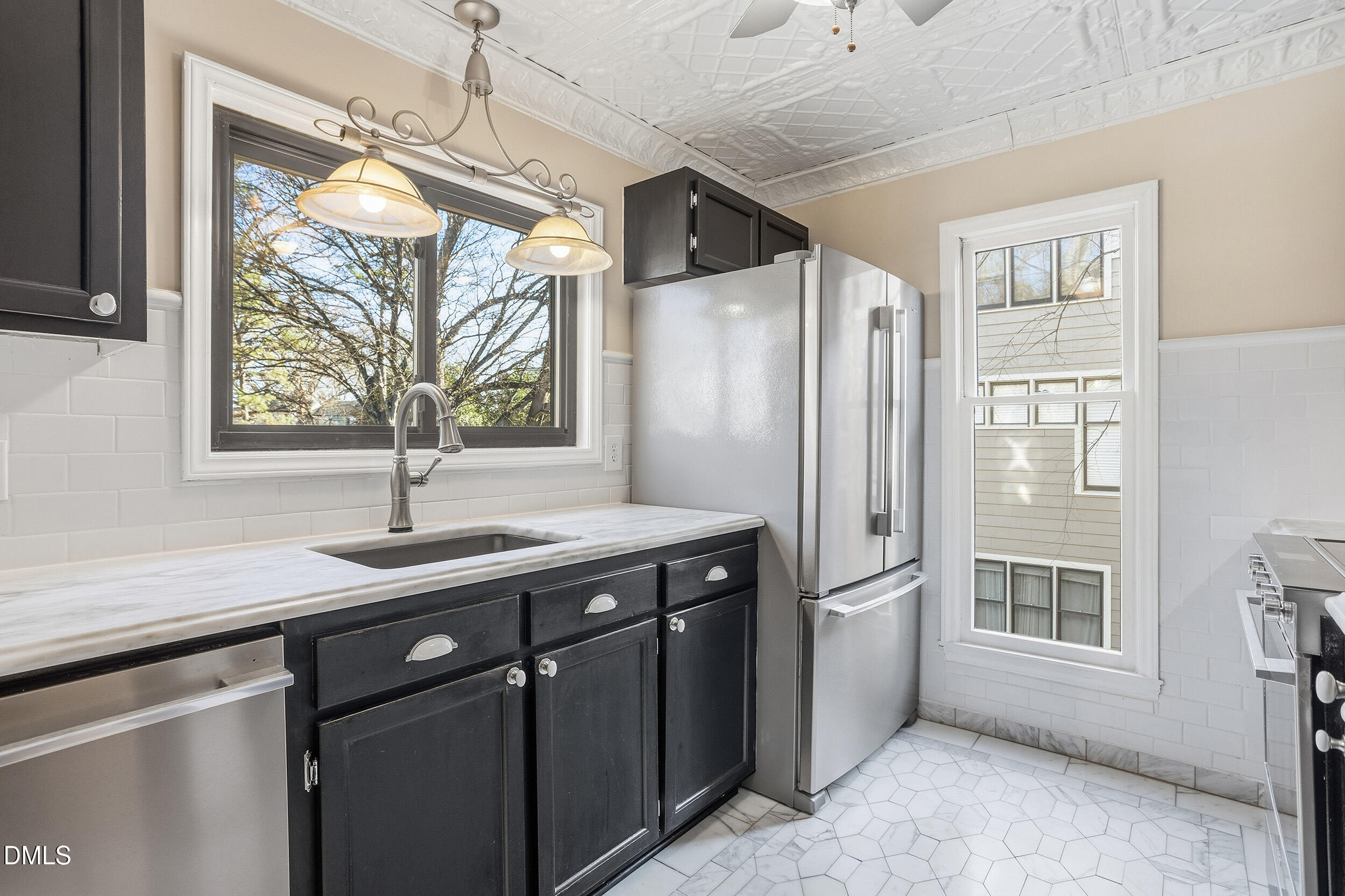 730 Washington Street, Unit 205 Raleigh, NC 27605 - Photo 8 of 23 a kitchen with stainless steel appliances granite countertop a refrigerator a sink and a window