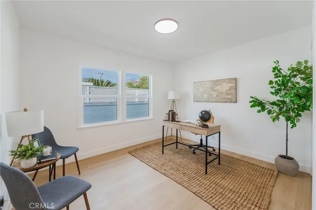 a living room with furniture a window and a potted plant