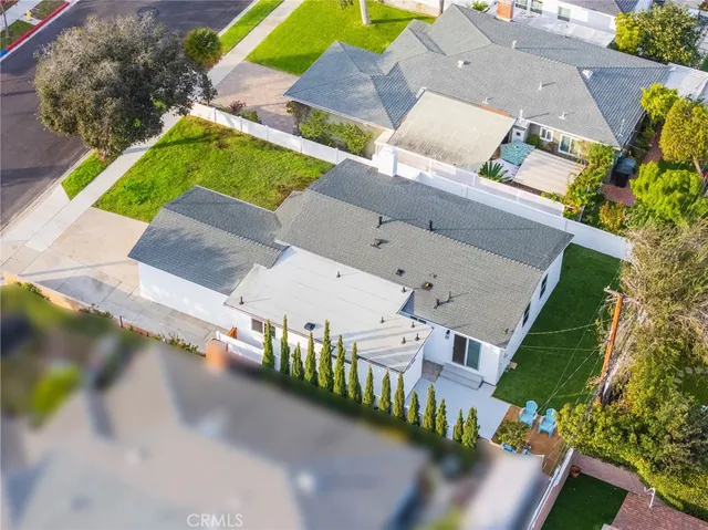 an aerial view of a house with a garden and trees