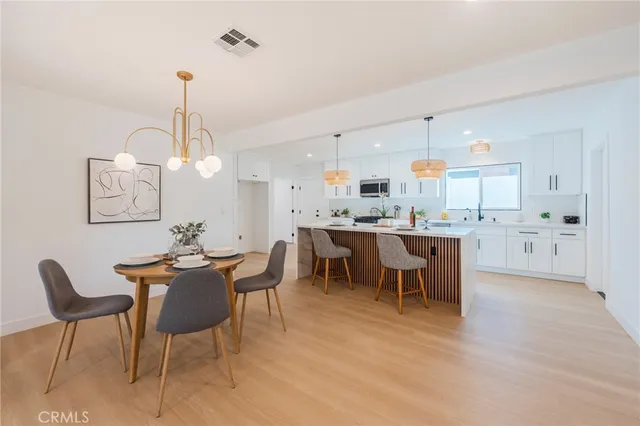 a large kitchen with a table and chairs