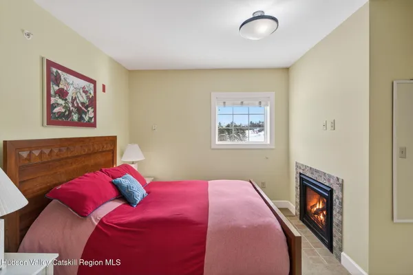 a bedroom with a bed and a painting on the wall