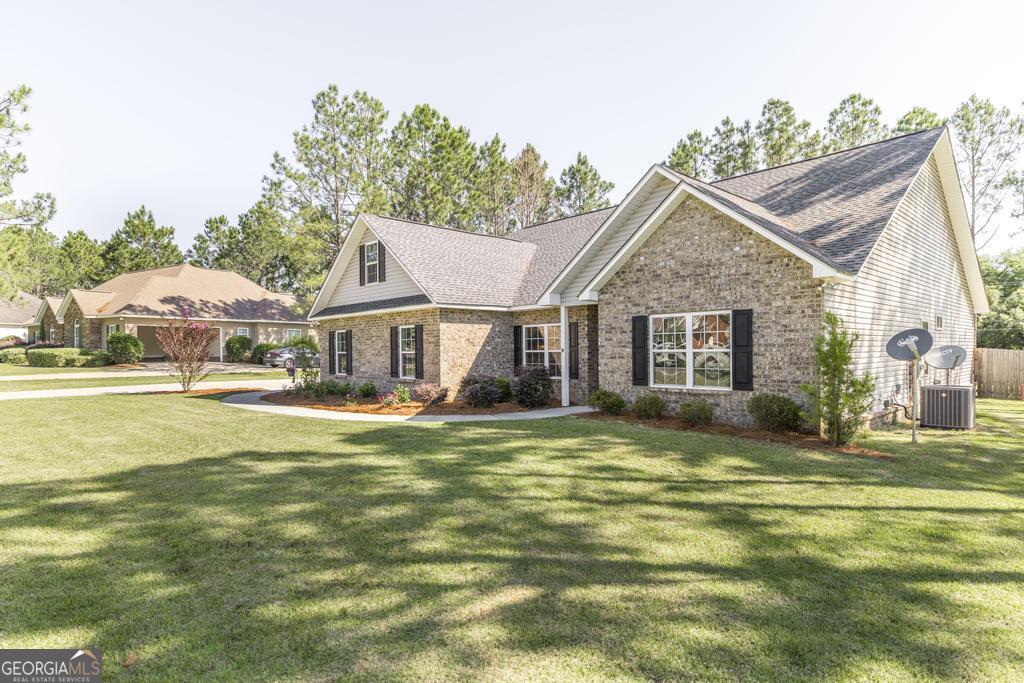 609 Live Oak Way Dublin, GA 31021 - Photo 5 of 37 a front view of a house with swimming pool having outdoor seating