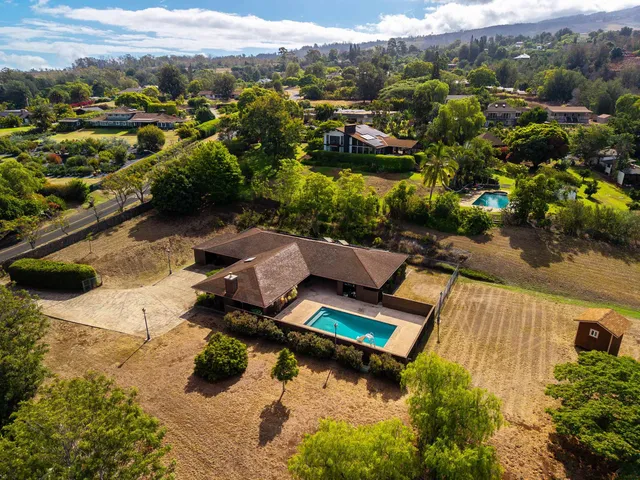 an aerial view of residential houses with outdoor space