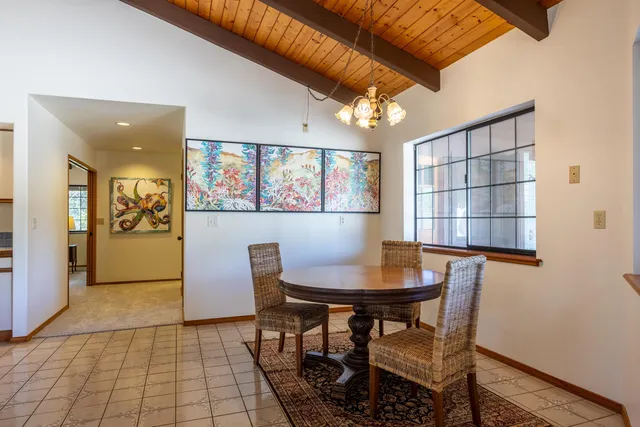 a view of a dining room with furniture and a window