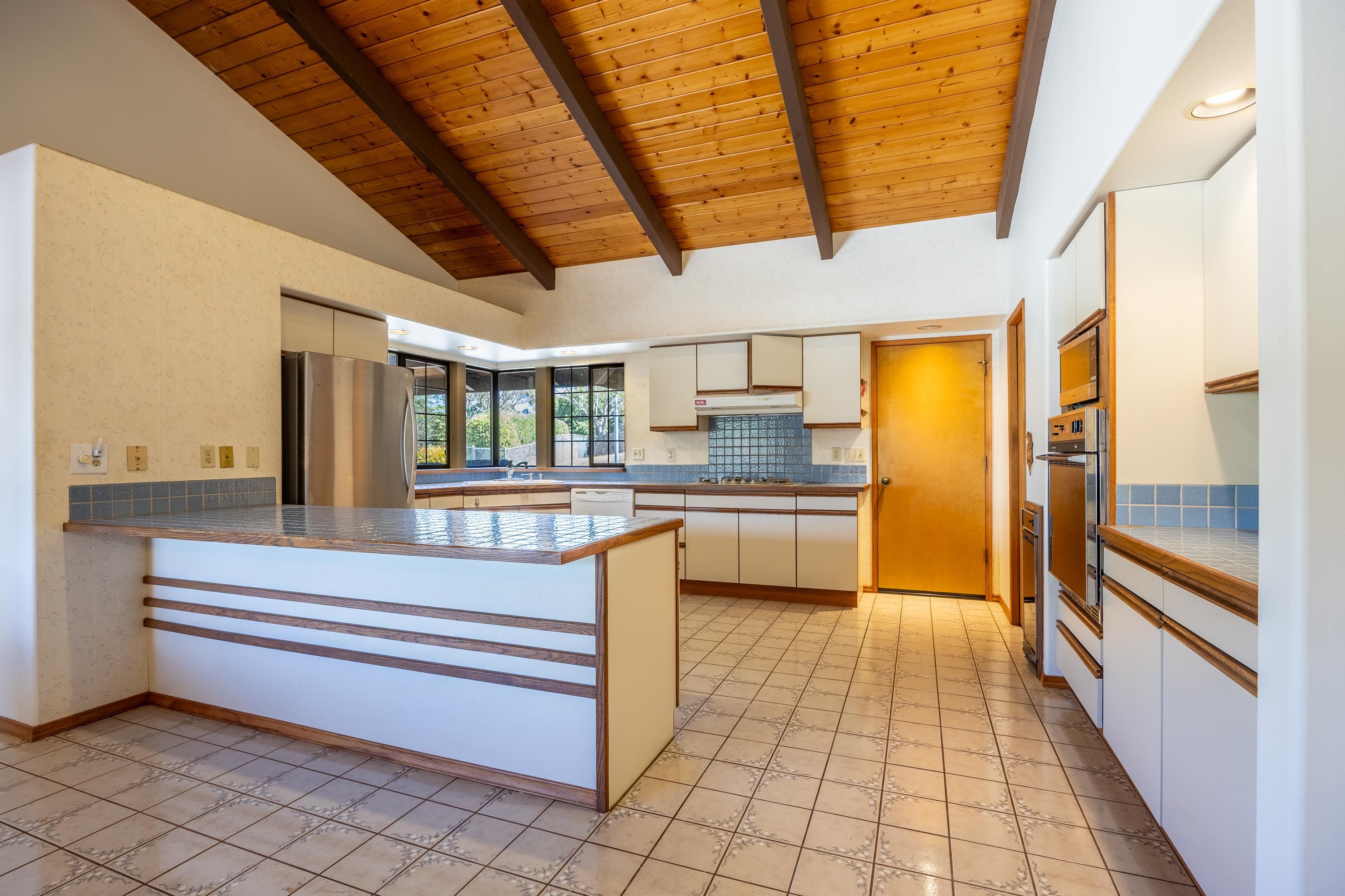 128 Hoopalua Drive Makawao, HI 96768 - Photo 16 of 50 a open kitchen with a sink and refrigerator