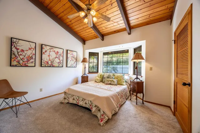 a bed sitting in a bedroom next to a window