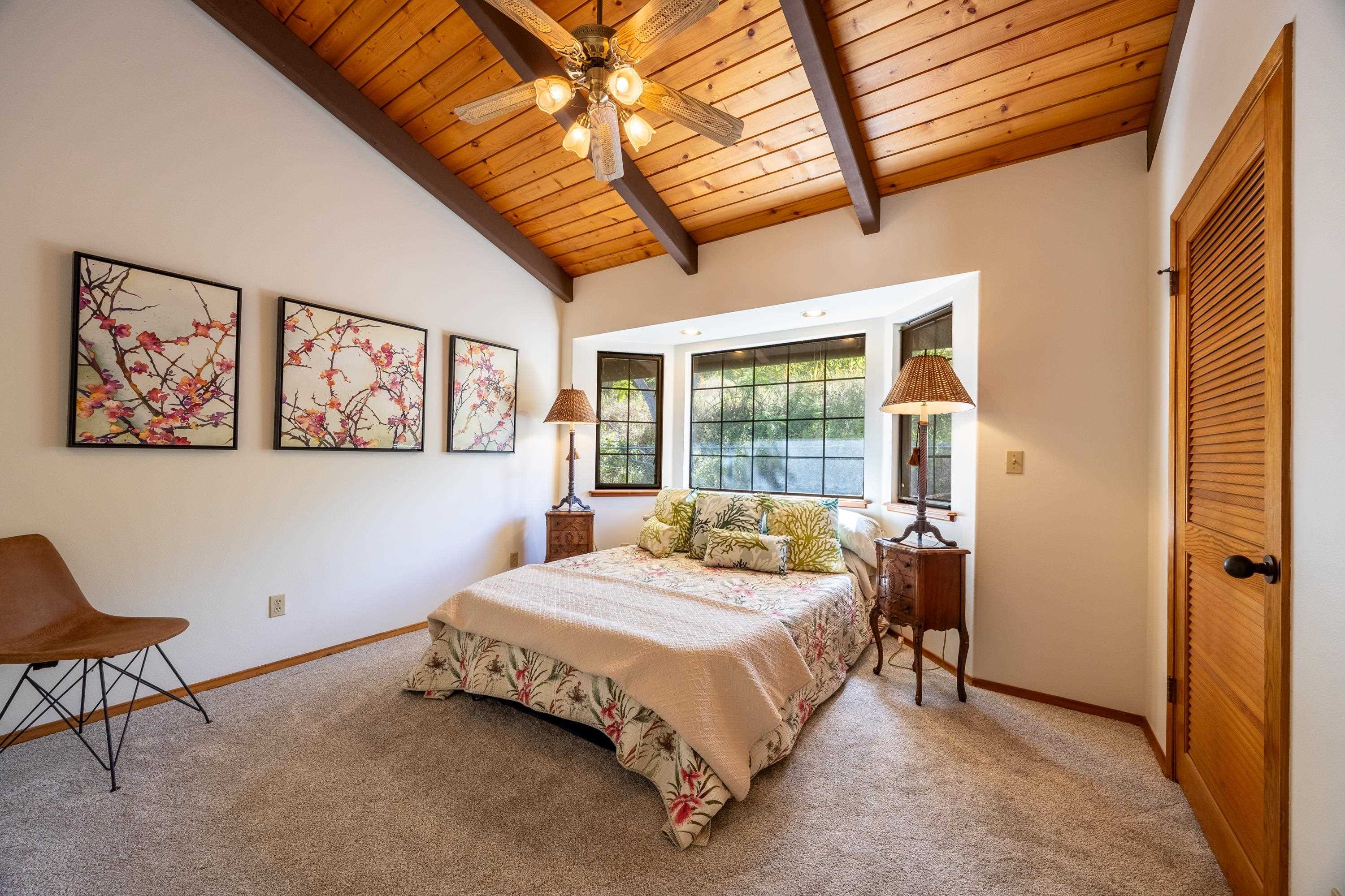 128 Hoopalua Drive Makawao, HI 96768 - Photo 20 of 50 a bed sitting in a bedroom next to a window