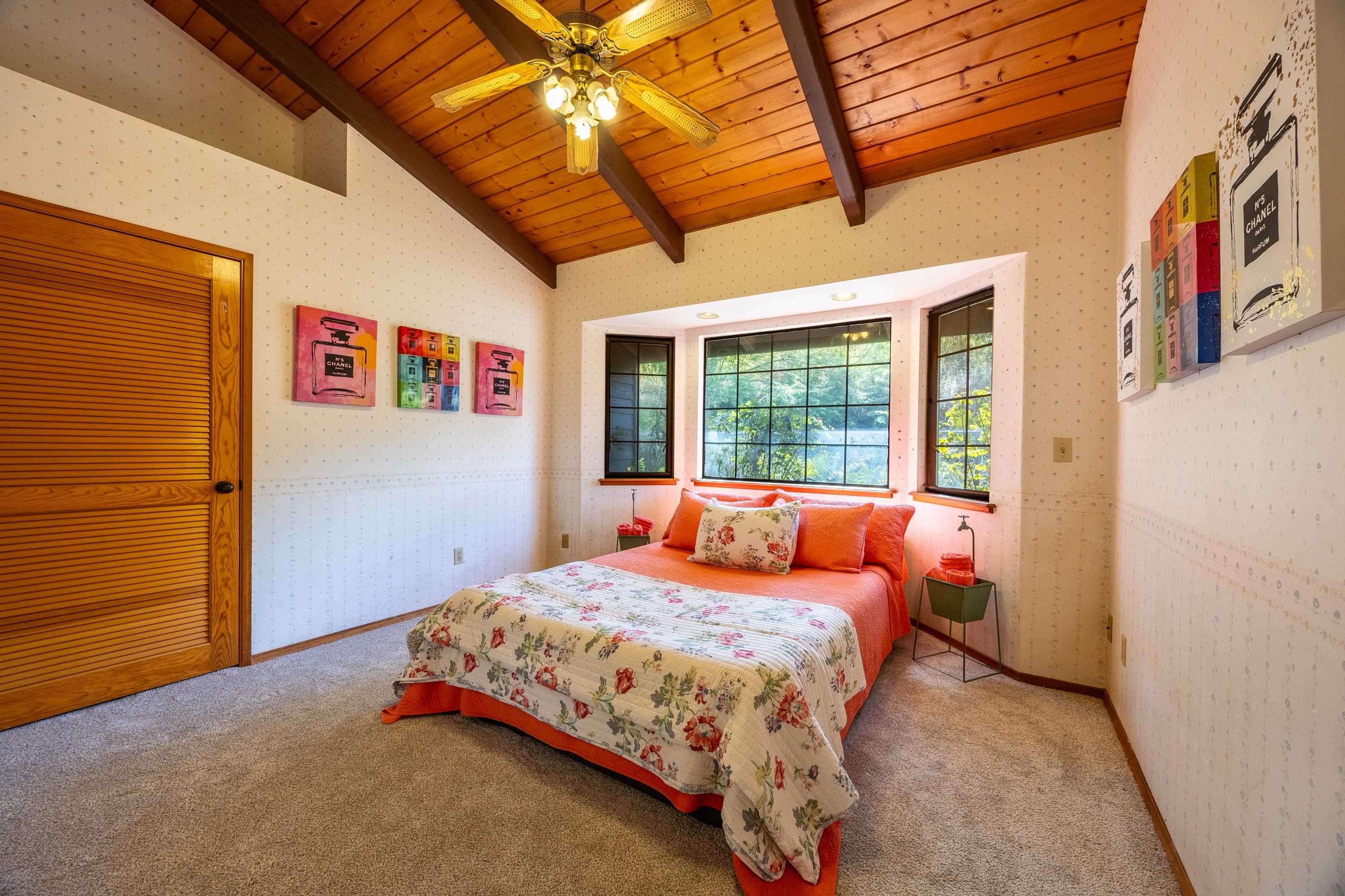128 Hoopalua Drive Makawao, HI 96768 - Photo 23 of 50 a bedroom with a bed and a large window