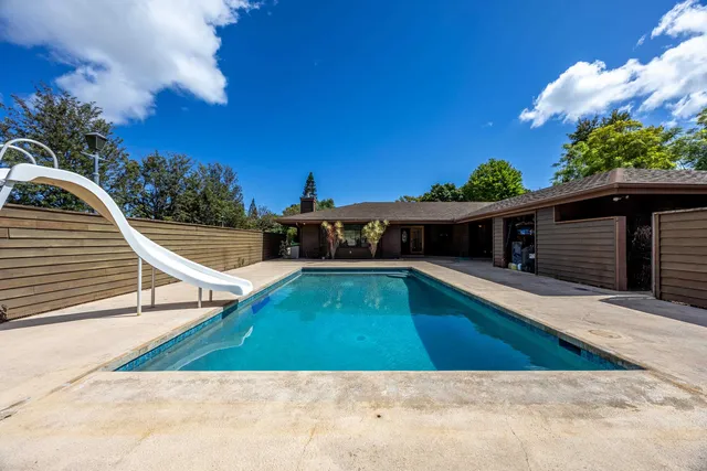 a view of a swimming pool with a chair