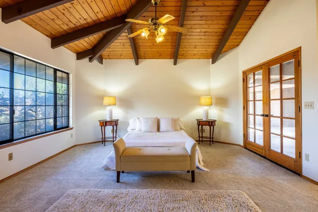 a bedroom with furniture and a large window