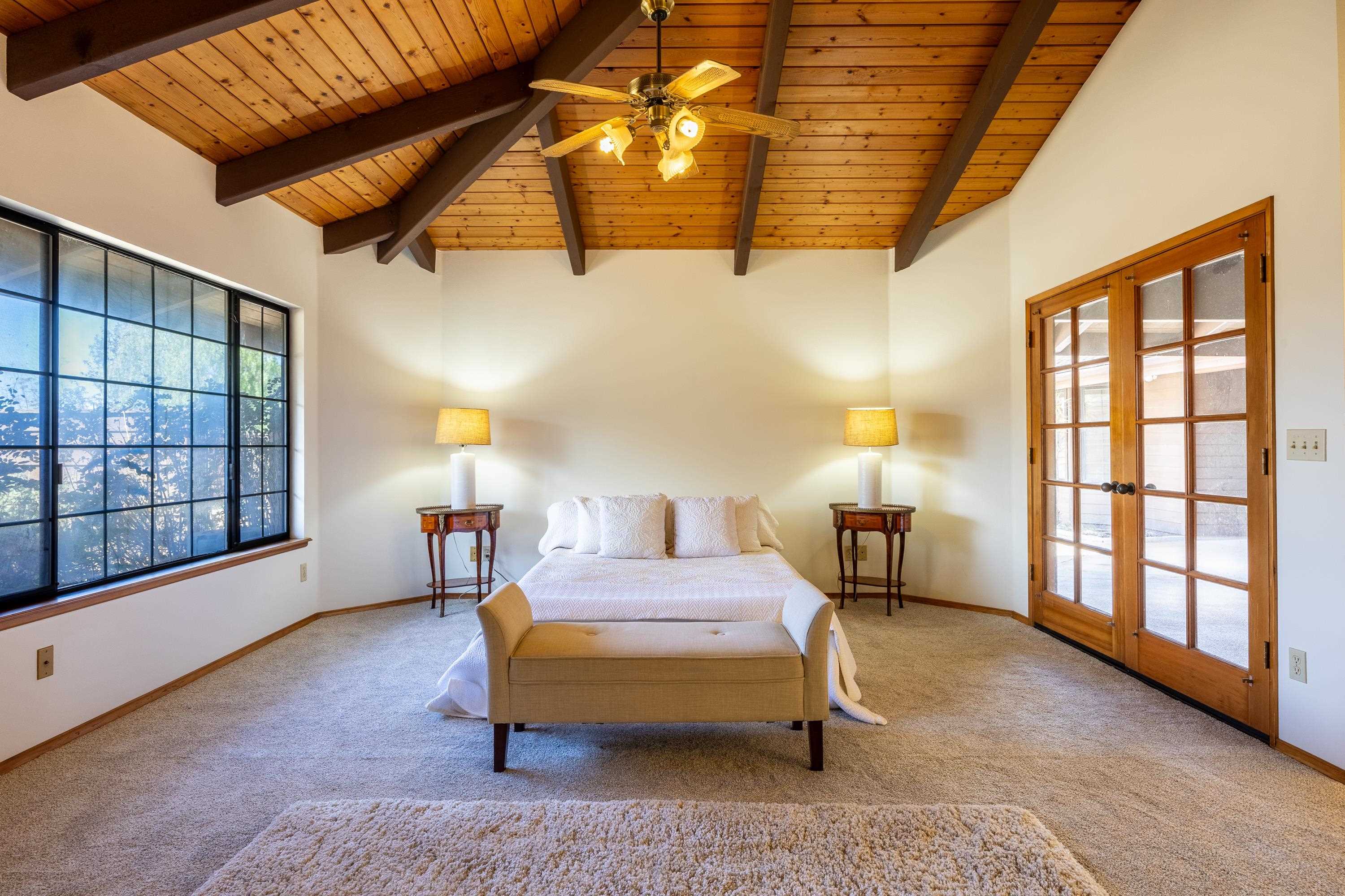 128 Hoopalua Drive Makawao, HI 96768 - Photo 25 of 50 a bedroom with furniture and a large window