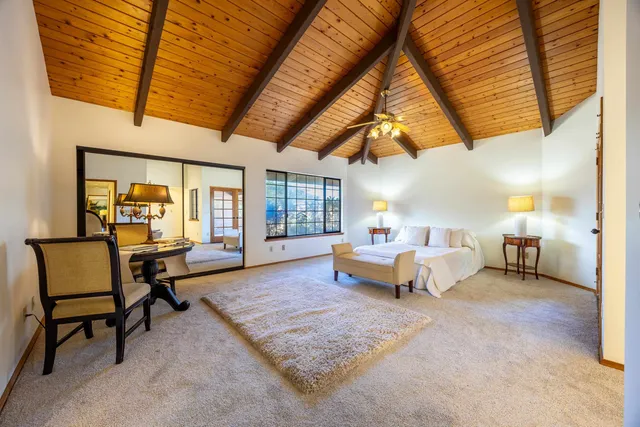 a living room with furniture a couch and next to a window