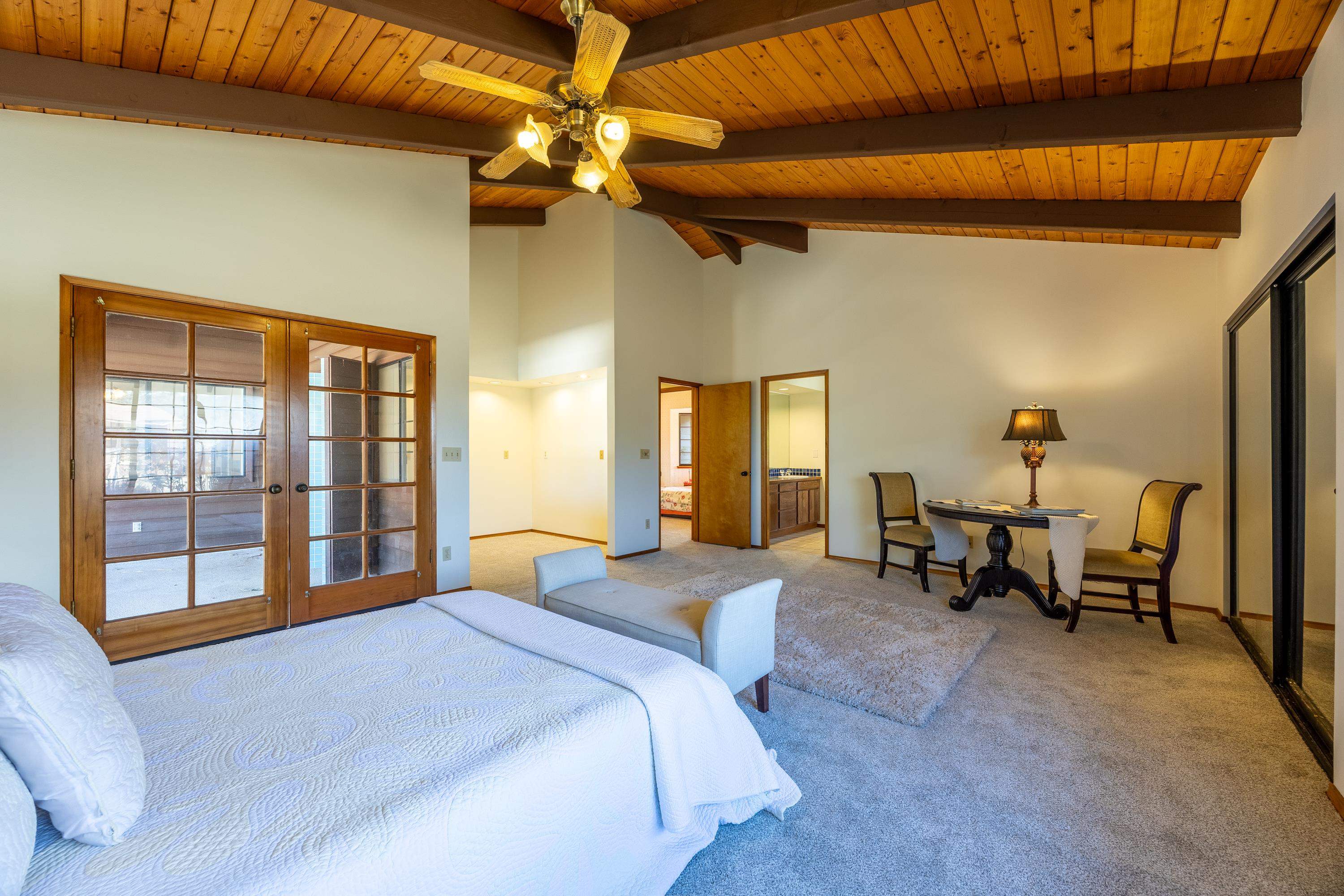 128 Hoopalua Drive Makawao, HI 96768 - Photo 27 of 50 a bedroom with a bed and a chandelier