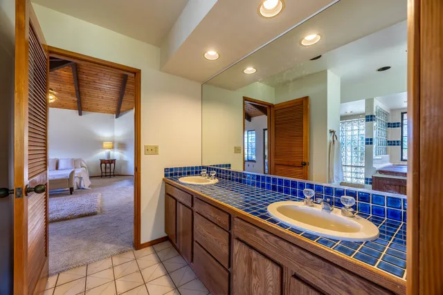 a spacious bathroom with a sink double vanity and a mirror