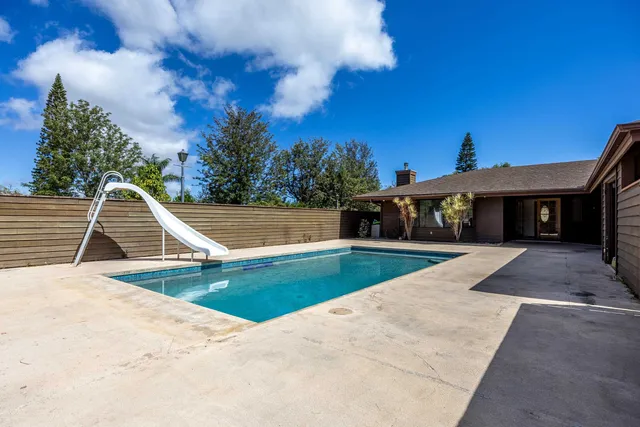 a view of a house with swimming pool