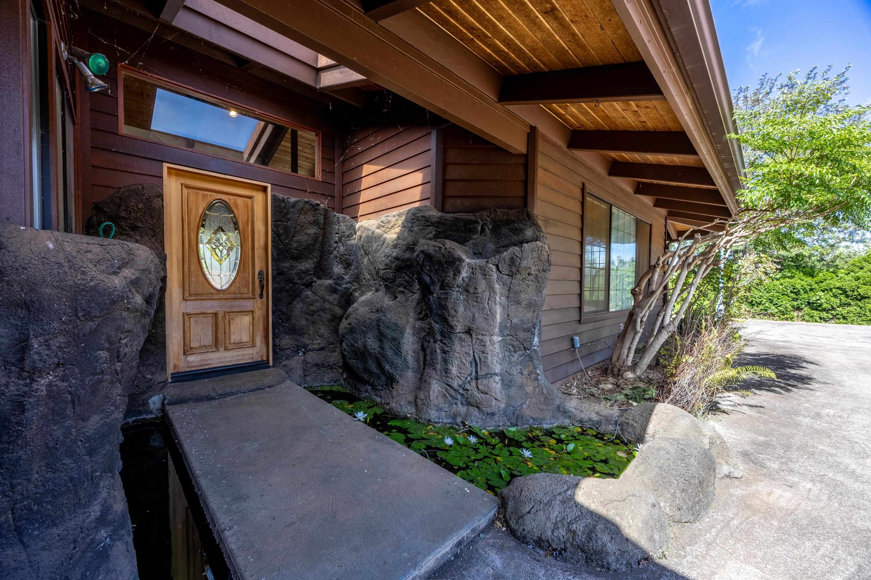 128 Hoopalua Drive Makawao, HI 96768 - Photo 5 of 50 a front view of a house with a yard