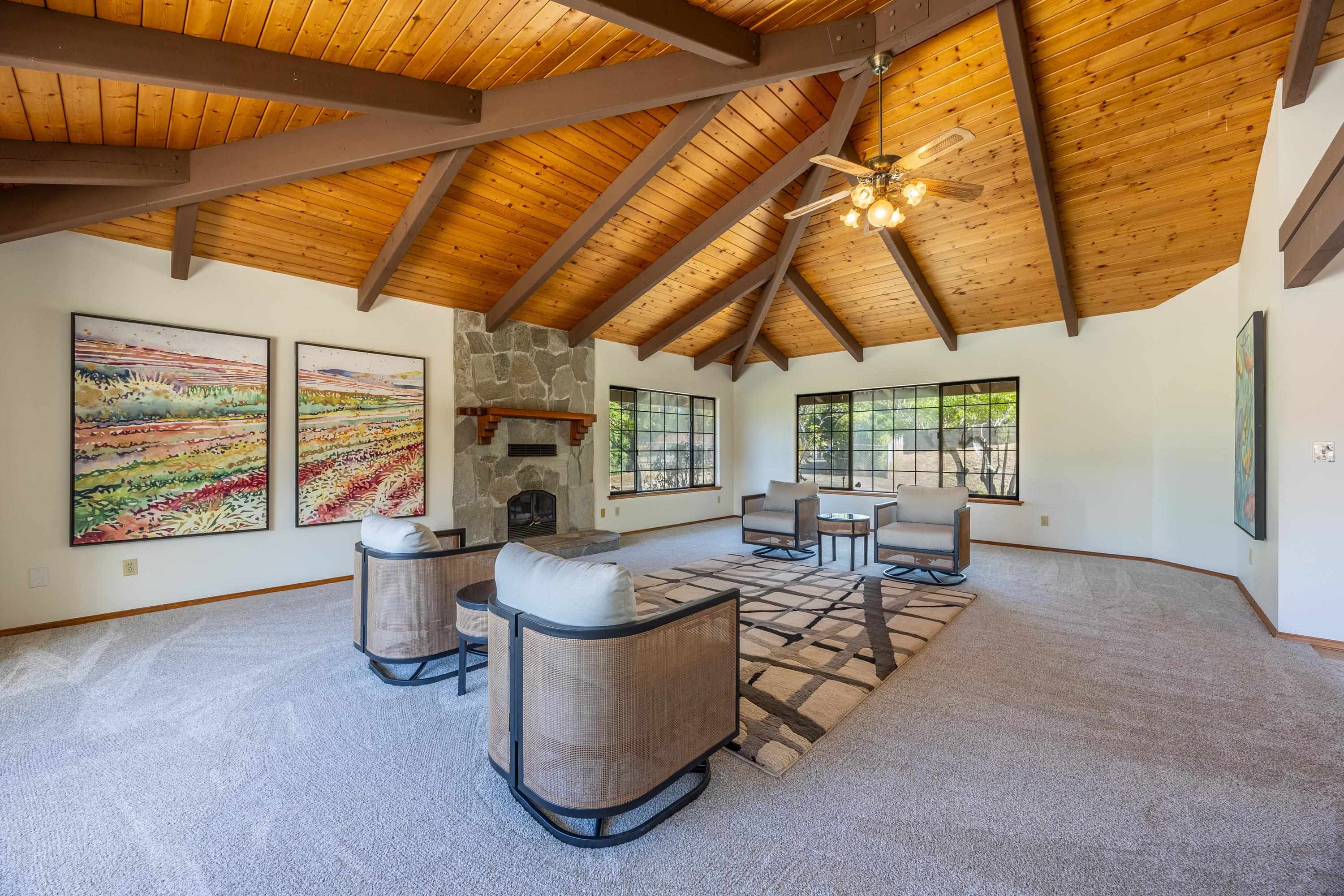 128 Hoopalua Drive Makawao, HI 96768 - Photo 9 of 50 a living room with fireplace furniture and a large window