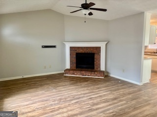 6460 Connell Road Atlanta, GA 30349 - Photo 4 of 21 a view of an empty room with a fireplace and a window