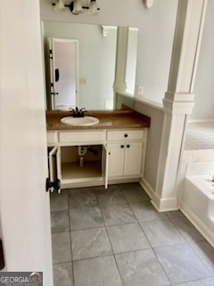 6460 Connell Road Atlanta, GA 30349 - Photo 7 of 21 a bathroom with a sink and a mirror