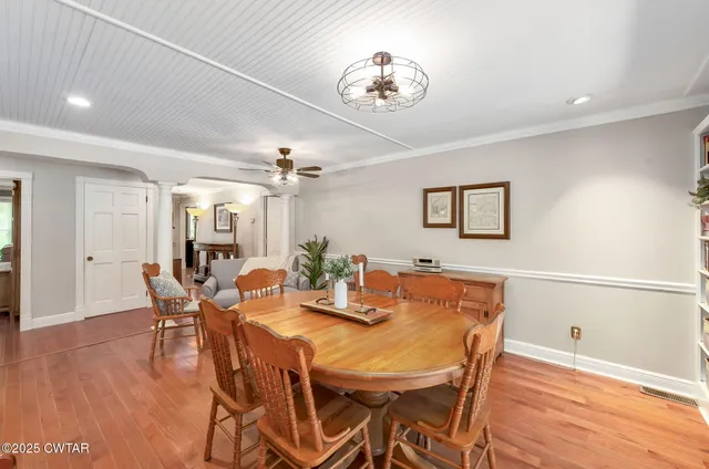 a view of a dining room with furniture and wooden floor