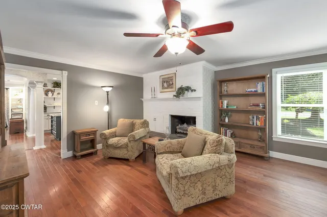 a living room with furniture and a fireplace