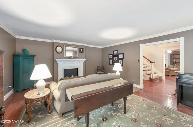 a living room with furniture a fireplace and a table