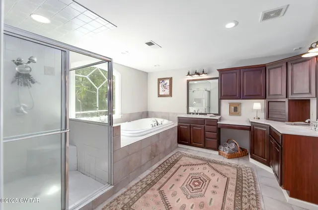 a kitchen with kitchen island granite countertop a sink and wooden cabinets