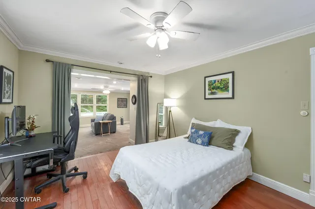 a spacious bedroom with a bed and a chandelier