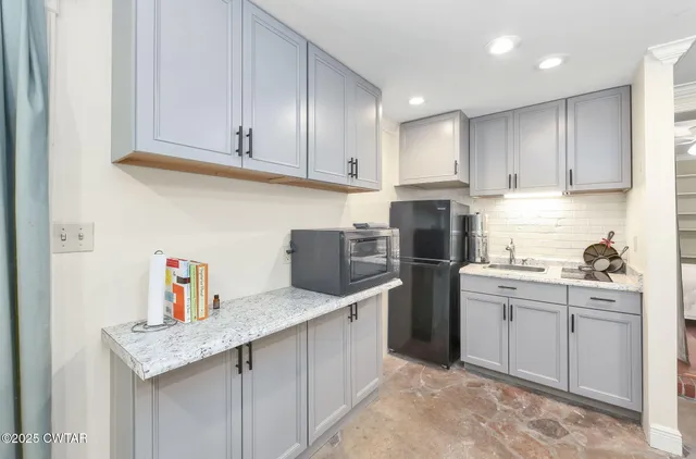 a kitchen with stainless steel appliances granite countertop a refrigerator sink and cabinets