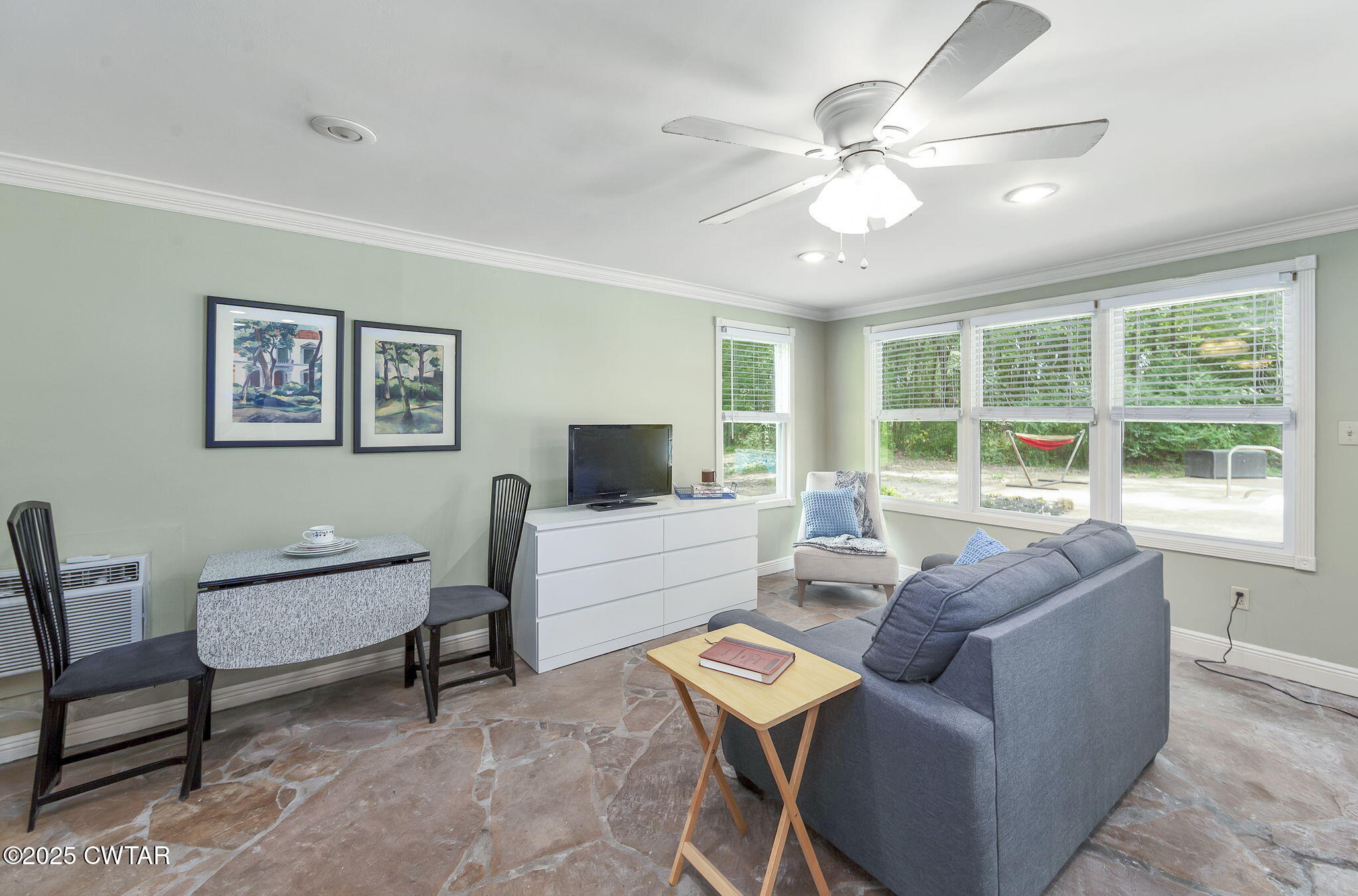 114 Old Stage Road Jackson, TN 38305 - Photo 35 of 50 a living room with furniture a large window and a flat screen tv