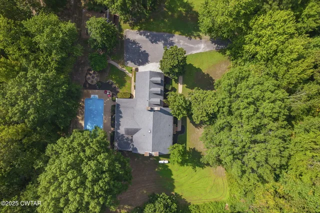 an aerial view of a house with a yard