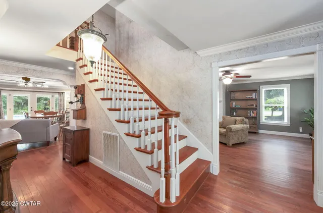 a view of entryway and hall with wooden floor
