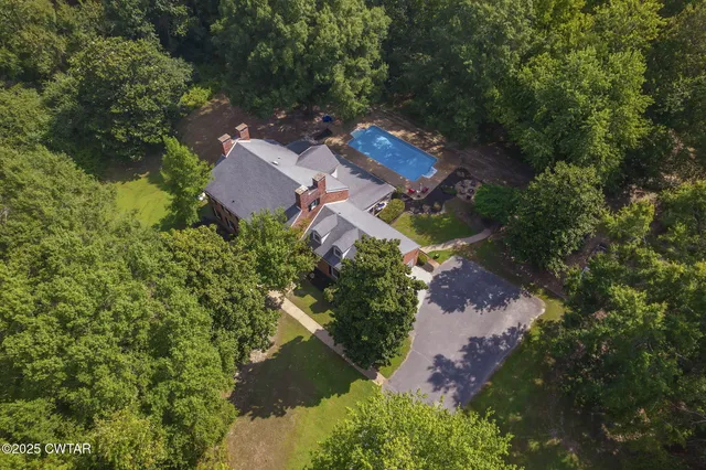 an aerial view of a house with yard