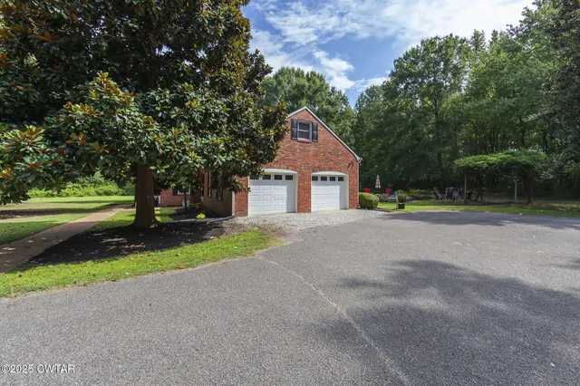 a house with huge green field in front of it