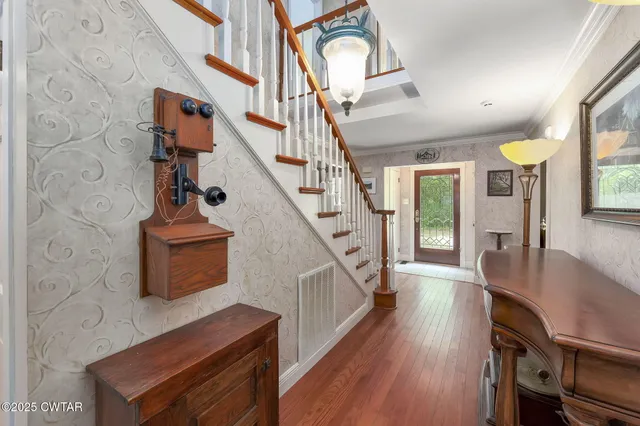 a view of entryway and hall with wooden floor