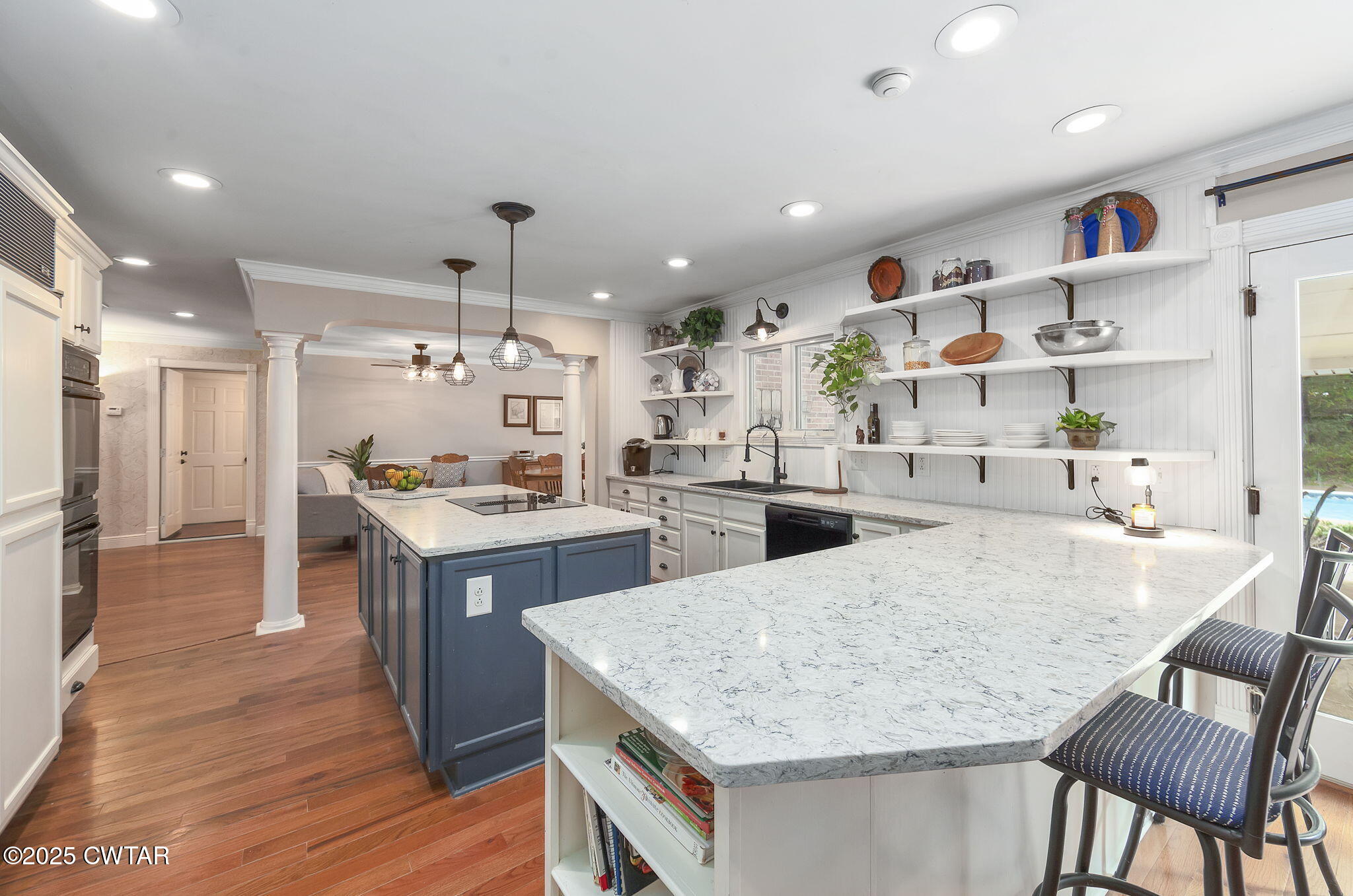 114 Old Stage Road Jackson, TN 38305 - Photo 6 of 50 a kitchen with kitchen island a stove a table and chairs in it